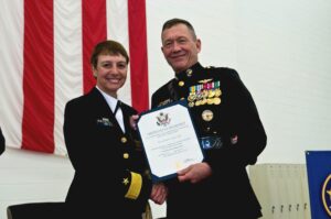 Rear Admiral C.J. Jaynes receiving a certificate