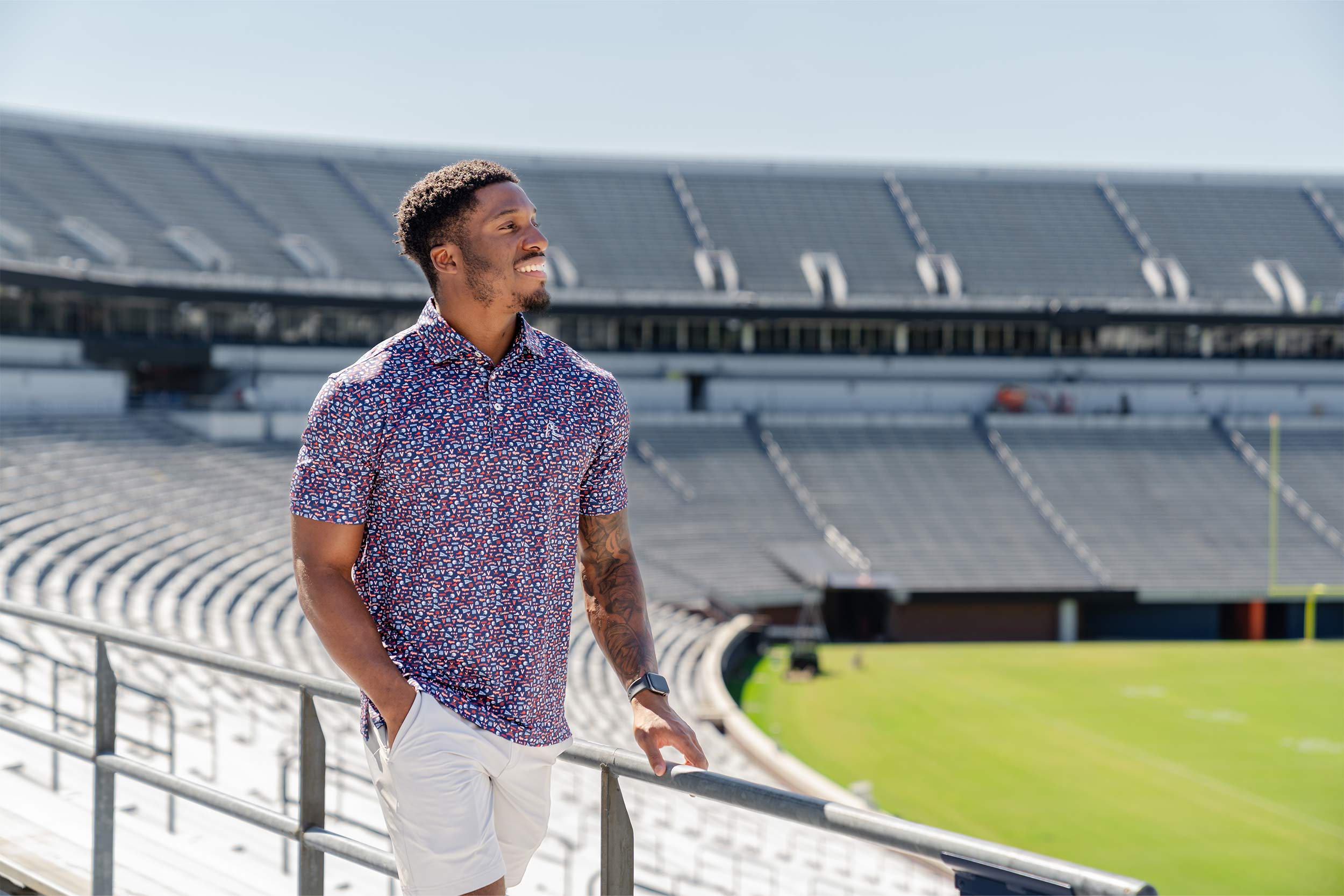 A photo of a man modeling a Rhoback polo at Scott Stadium.