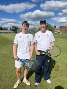 Two men holding tennis rackets.