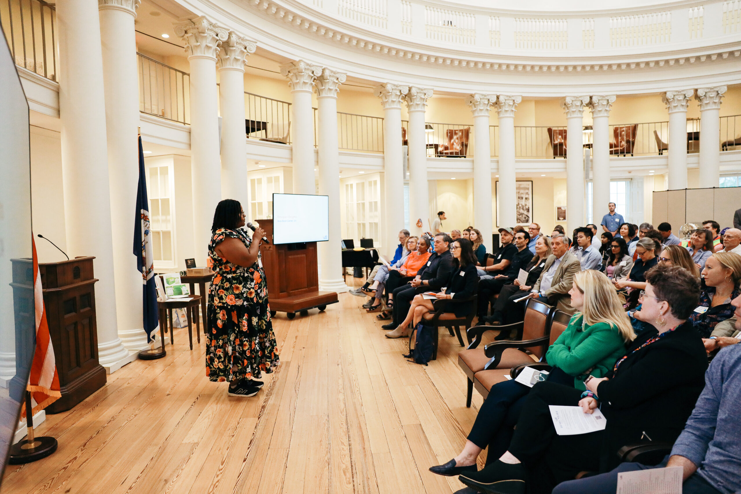 Beza Bisrat standing and speaking to a crowd seated in UVA's Rotunda.