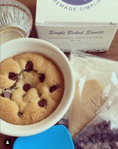 A photo of a chocolate chip treat in a ramekin.